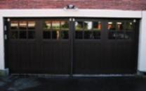 A custom sliding carriage style garage door on the waterfront